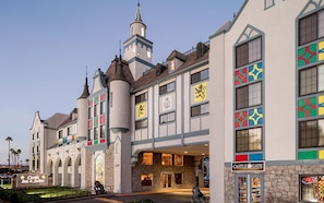 A castle-themed building with a prominent tower, a sign for 'Castle Gate,' and a 'Castle Inn & Suites' sign.