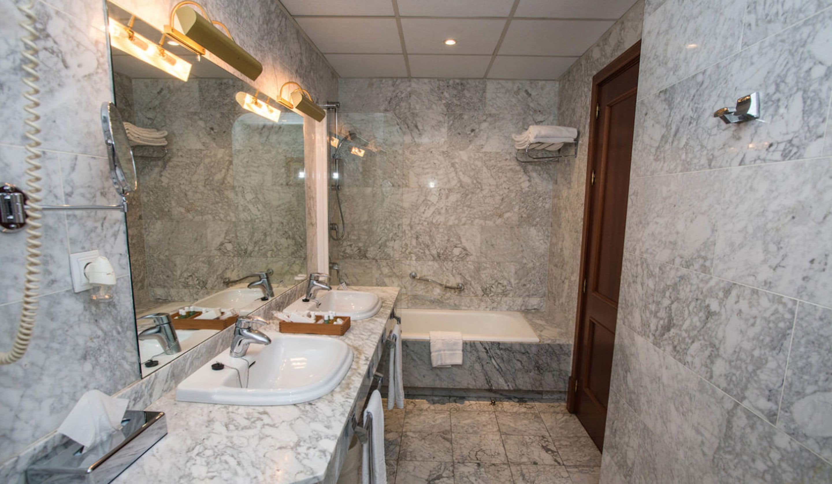 bathtub, designer toiletries, hair dryer, bathrobes