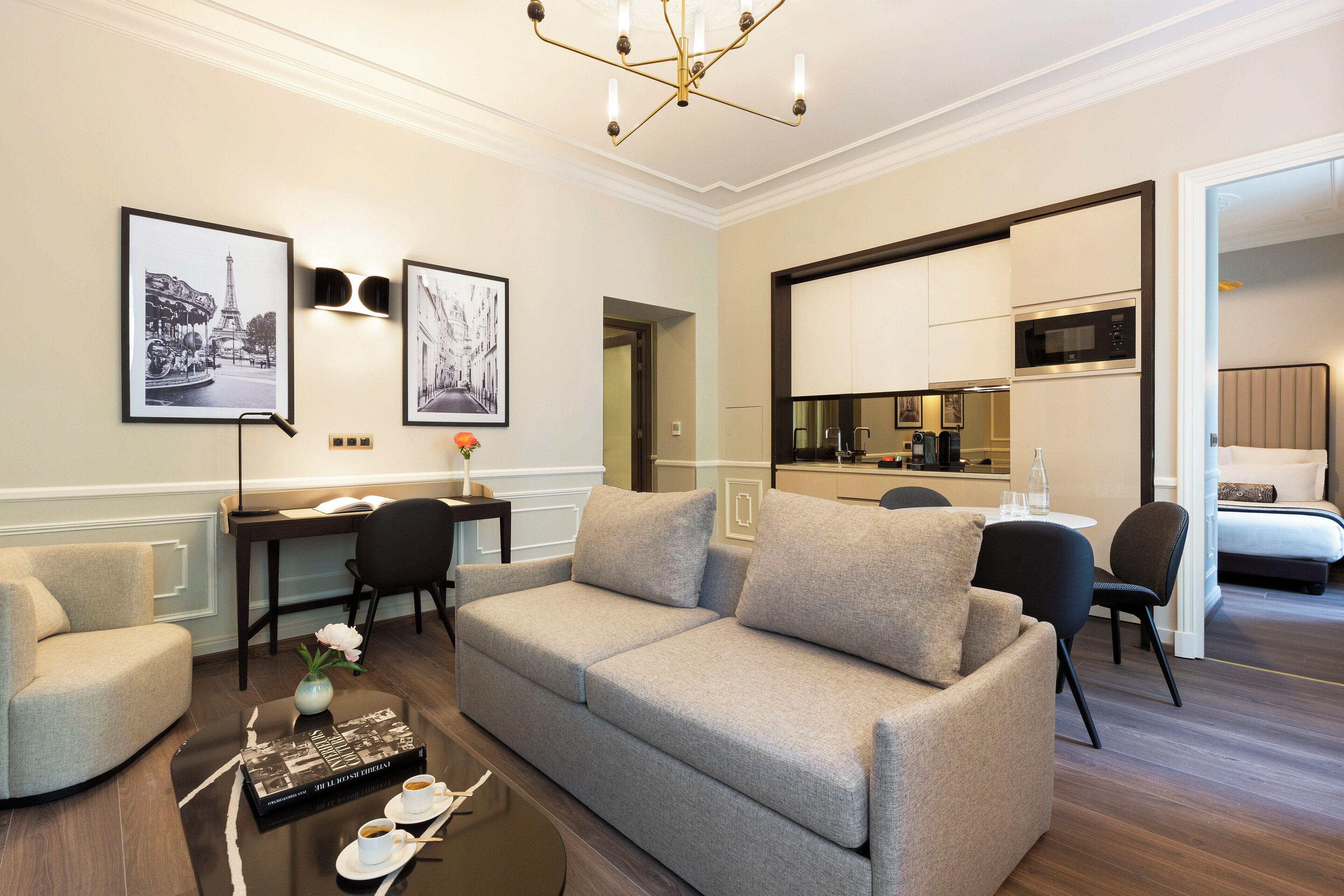 A modern living room with a sofa, coffee table, and artwork on the walls.