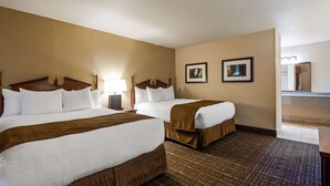 A hotel room with two beds, a large mirror, and two framed pictures on the wall. - Best Western Lakewood (Lakewood)
