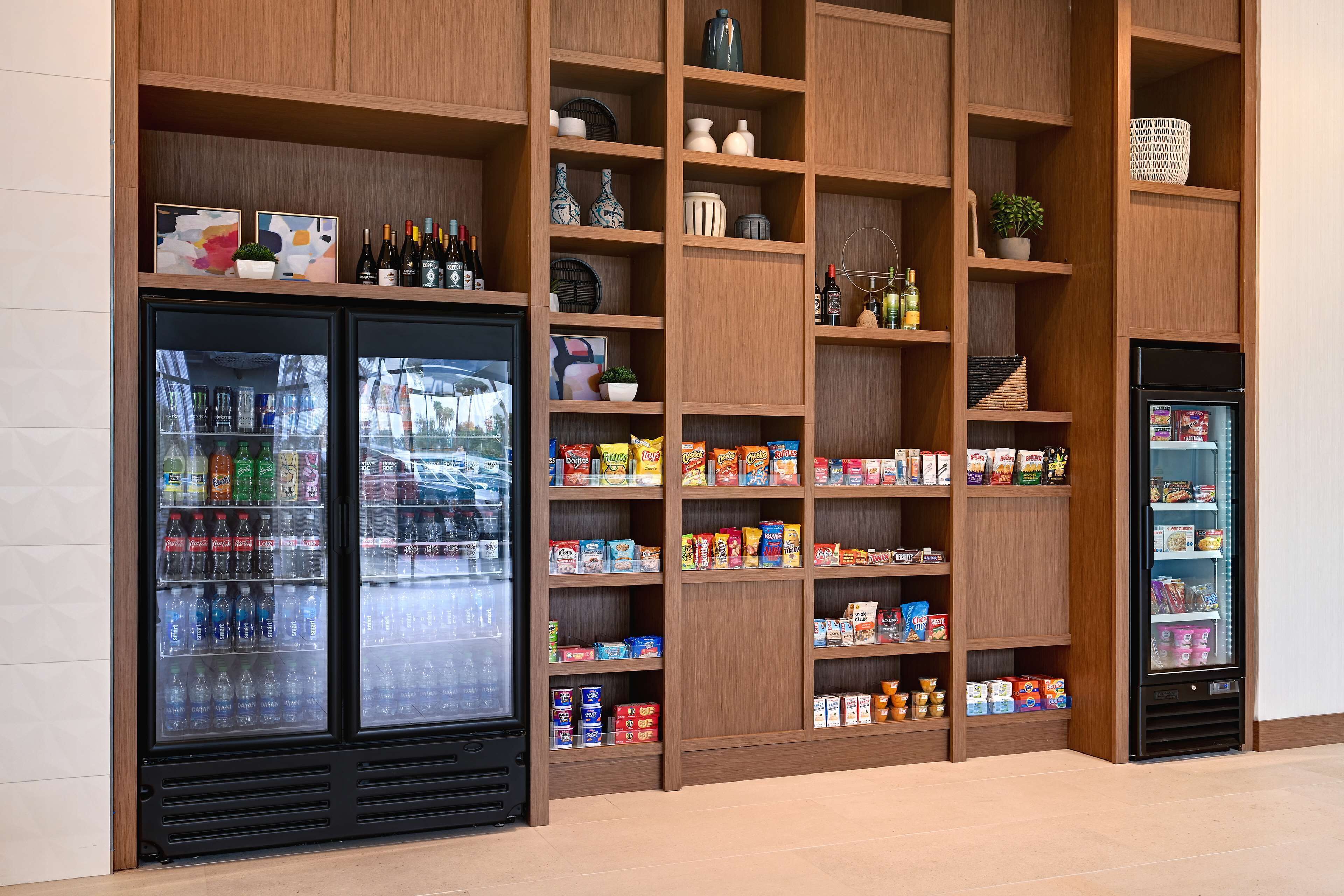 A refrigerated display case with bottled beverages and snacks.