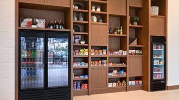 A refrigerated display case with bottled beverages and snacks.