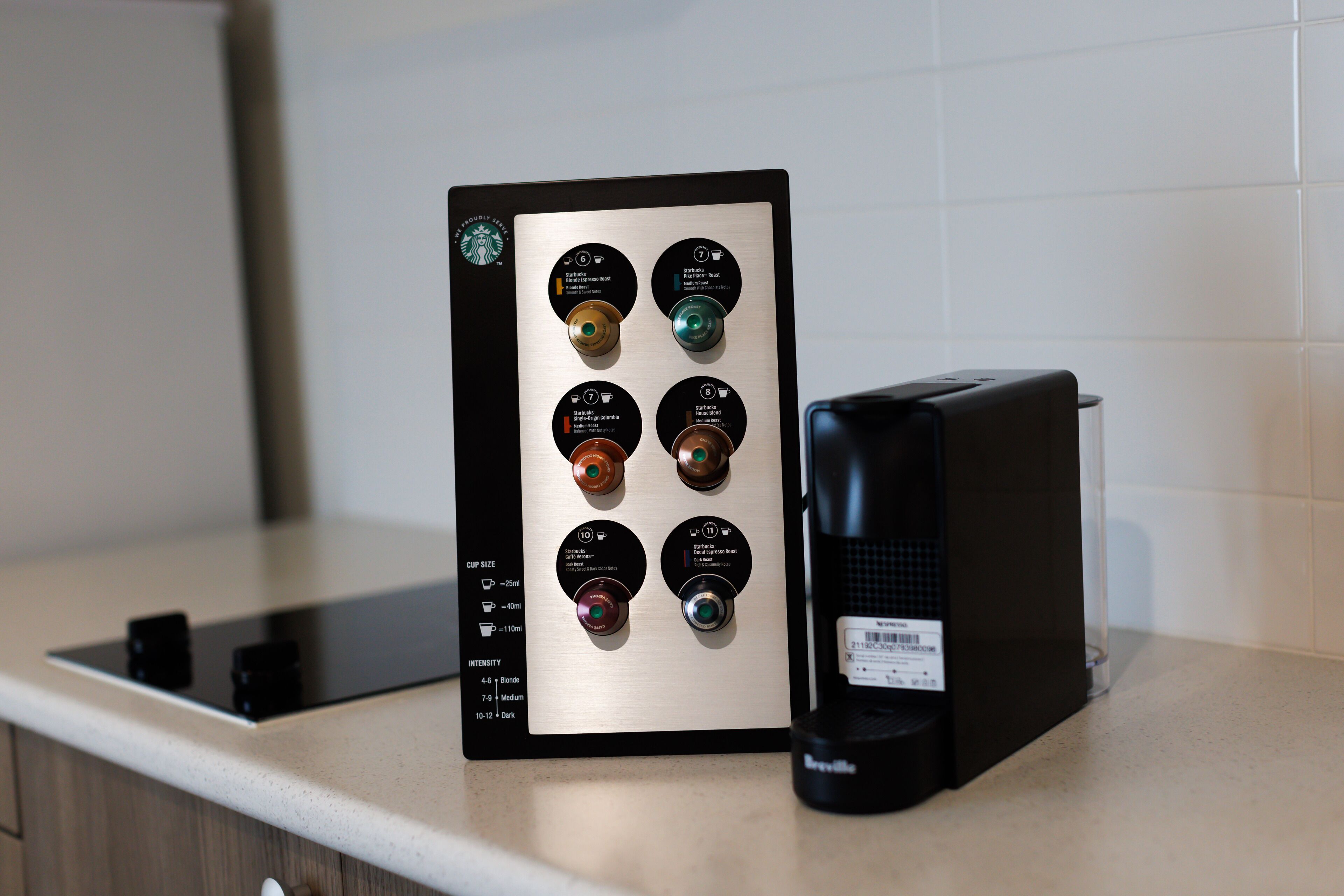 A coffee machine with multiple brewing settings and a coffee pod holder on a kitchen counter.