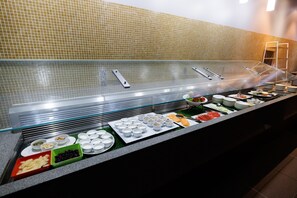 A buffet with various food items and containers.