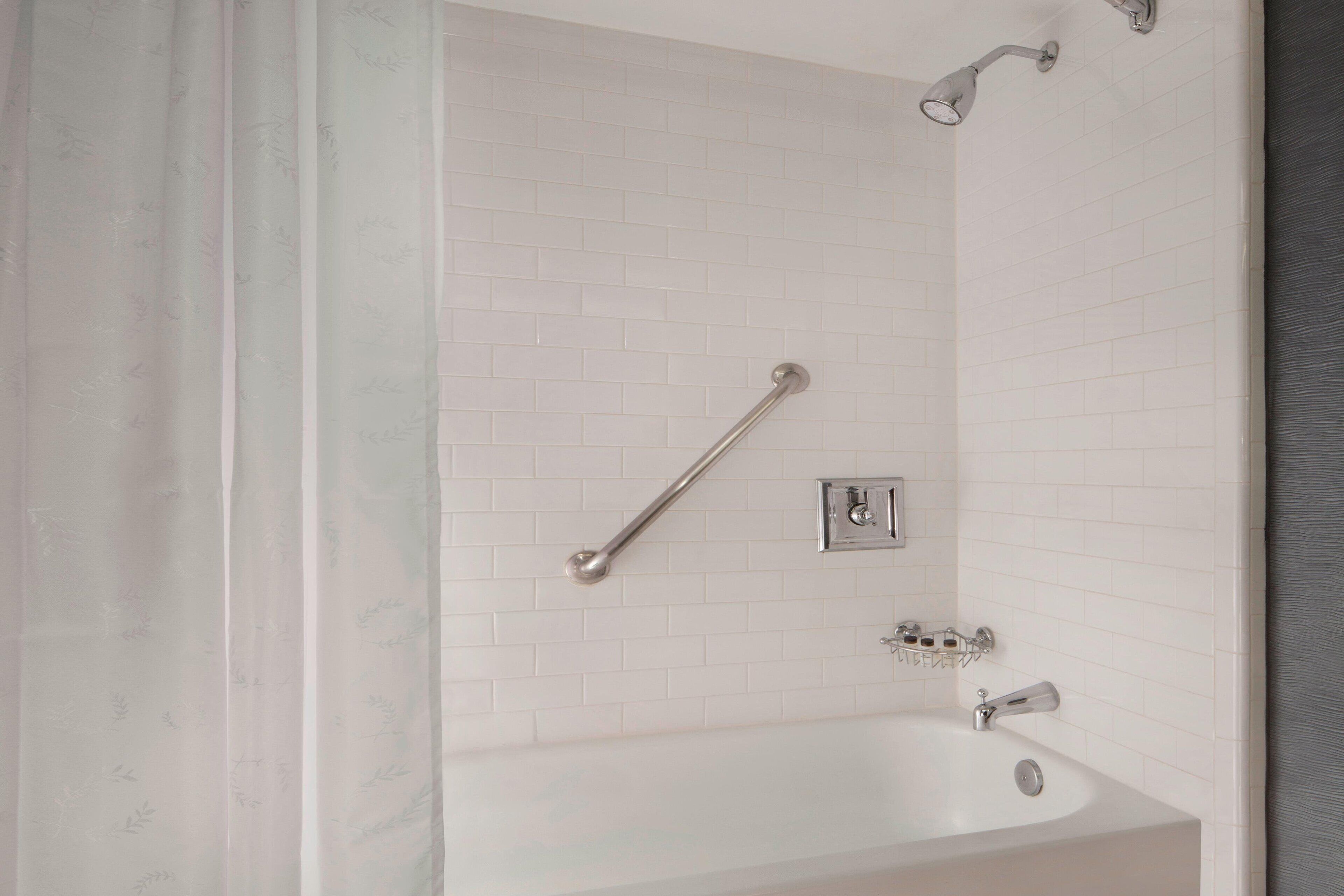 combined shower/bathtub, designer toiletries, hair dryer, towels