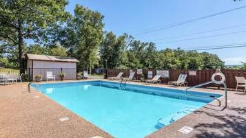Guests can enjoy a refreshing swim in the pool surrounded by a textured deck.