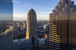 A high-rise building with a distinctive architectural style, surrounded by other tall buildings in an urban setting.