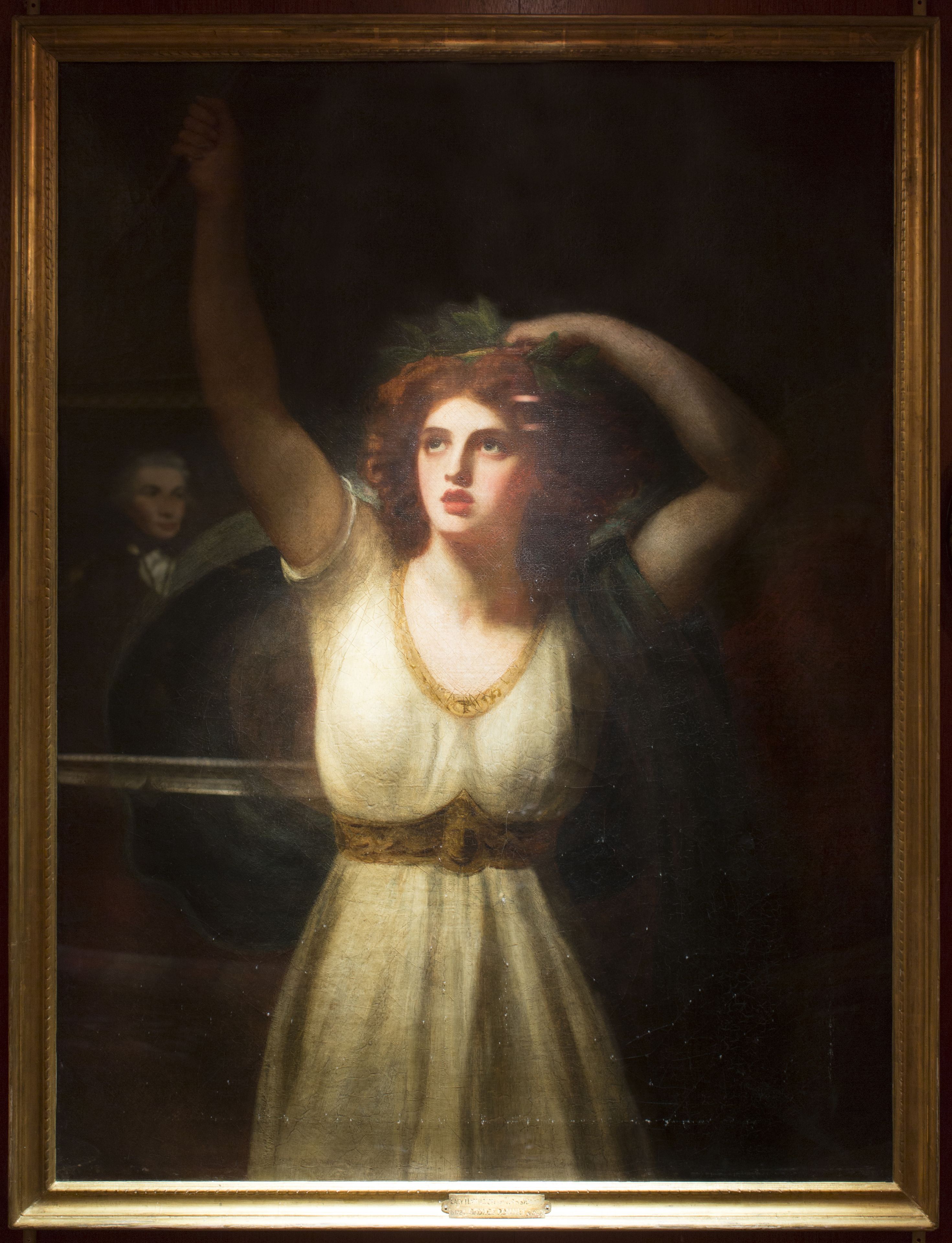 A classical painting with a figure in a dress, a frame, and a visible inscription at the bottom.
