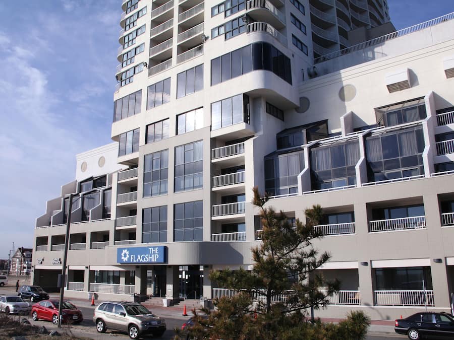 A multi-story hotel with a modern architectural design, featuring balconies and large windows.