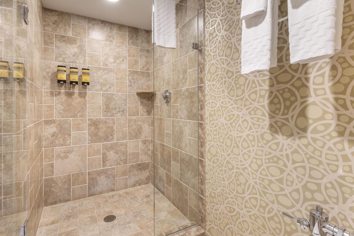 suite, 1 queen bed, non smoking, refrigerator & microwave | bathroom | eco-friendly toiletries, hair dryer, towels, soap