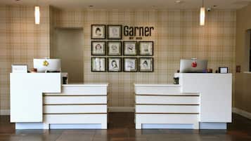 A reception desk with a check-in counter, framed artwork on the wall, and a modern design.