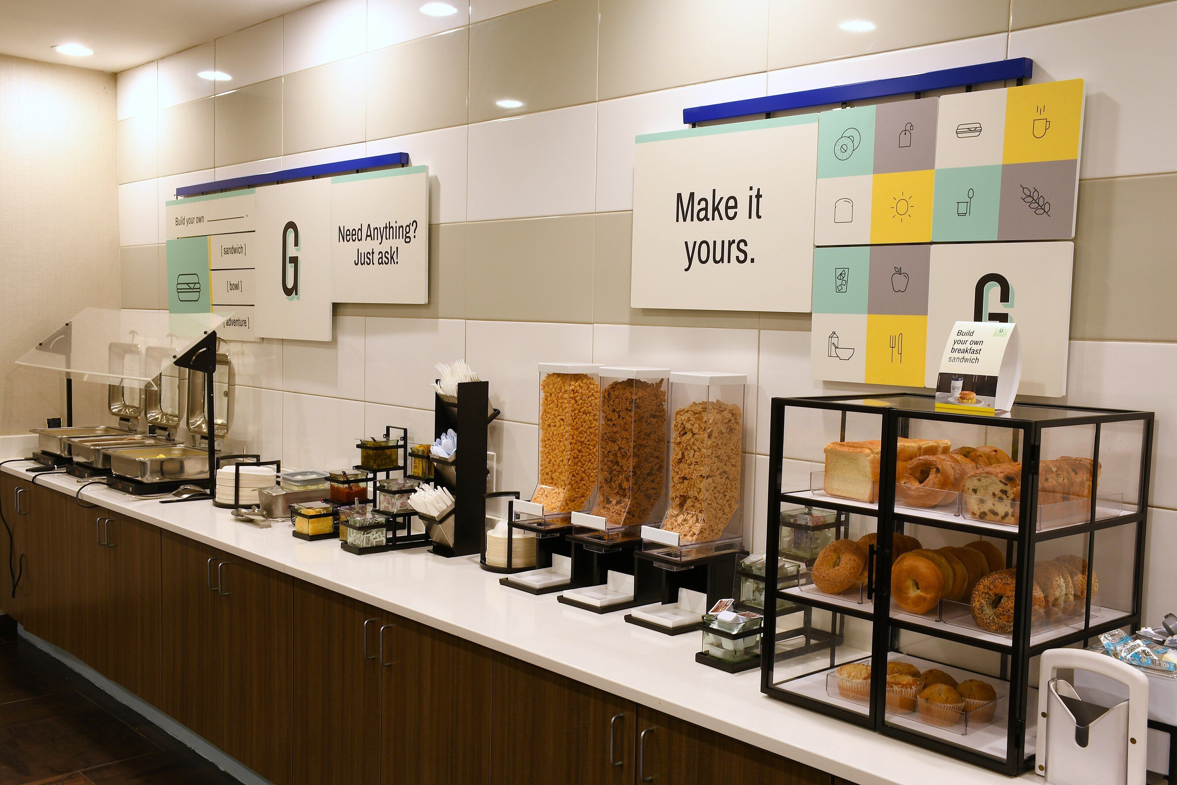A breakfast buffet with various food items and a sign that says 'Make it yours.'