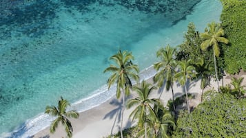 On the beach, white sand, sun loungers, beach towels