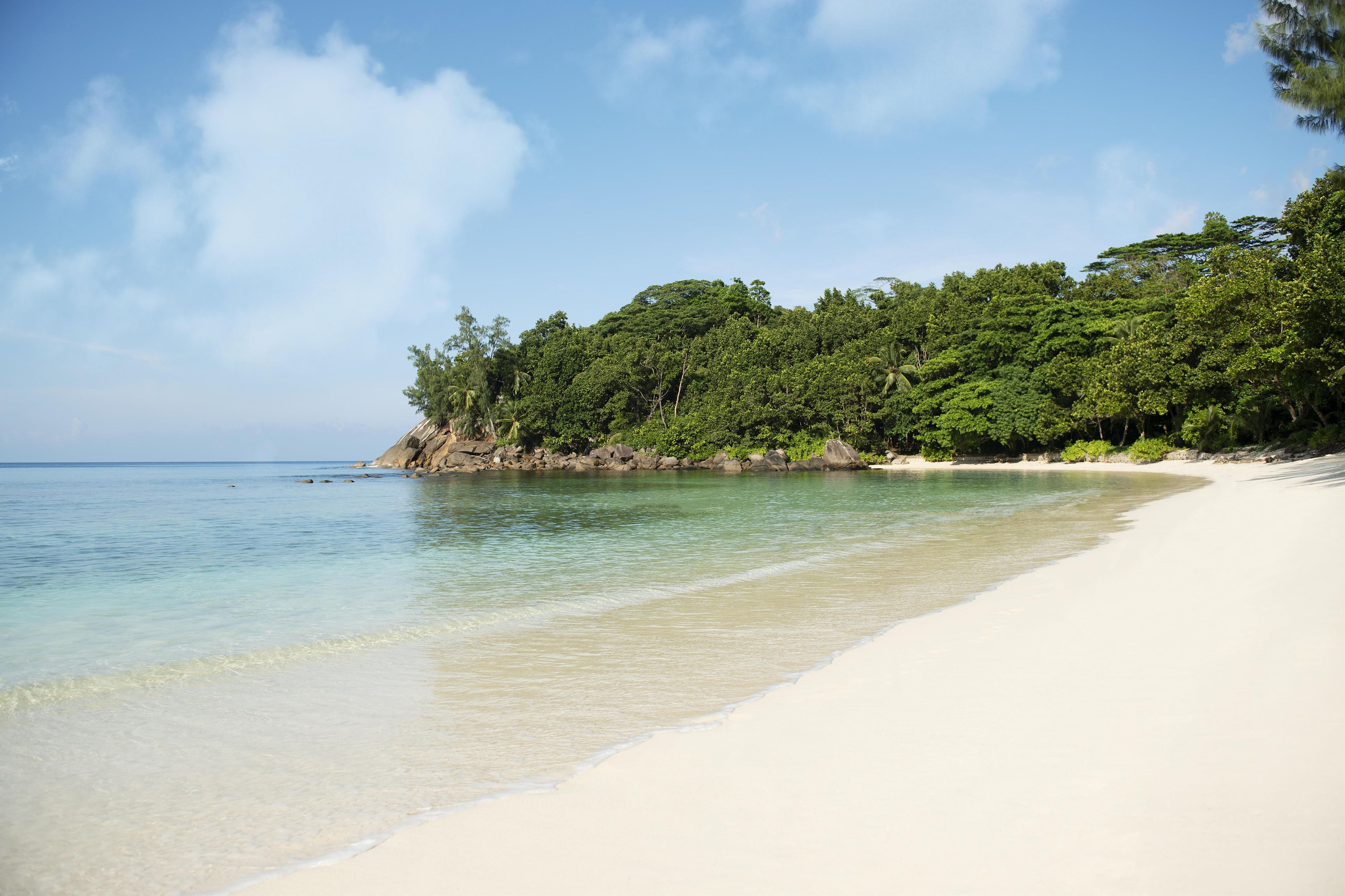 On the beach, white sand, sun loungers, beach towels