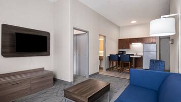 A modern living room with a flat-screen TV, a sofa, and a coffee table.