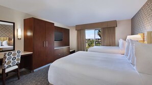 A hotel room with two beds, a desk, a TV, and a large window with a view. - Embassy Suites by Hilton Anaheim North (Anaheim)