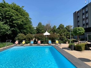 Seasonal outdoor pool, open 9 AM to 9 PM, pool umbrellas, pool loungers
