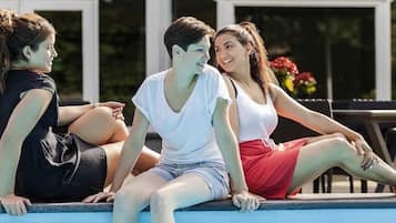 Seasonal outdoor pool, open 9 AM to 9 PM, pool umbrellas, pool loungers