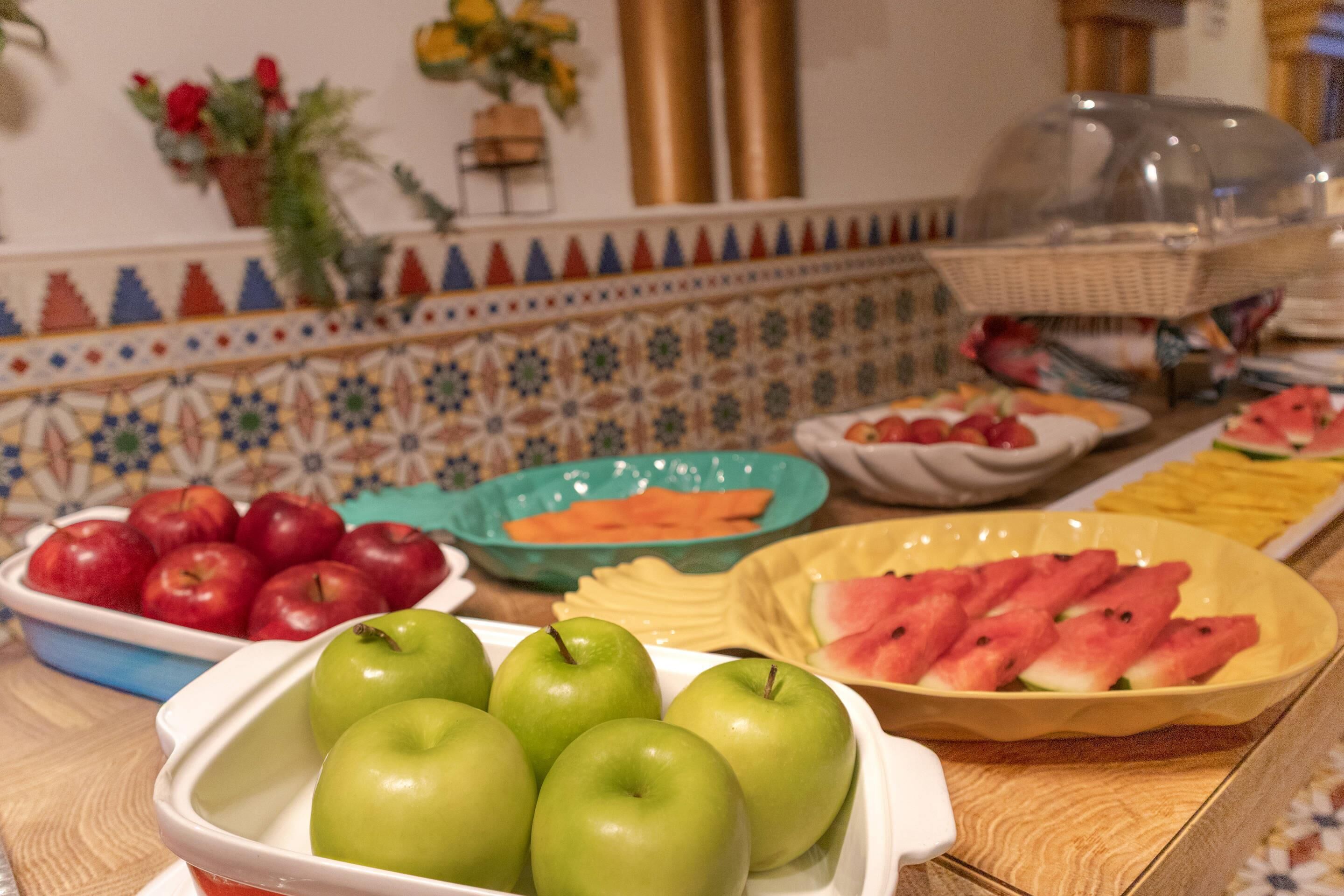 A buffet table with various fruits and vegetables.