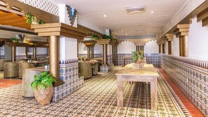 A spacious lobby with patterned tile flooring, wooden furniture, and decorative plants. - Hotel Faranda Express Puerta Del Sol Barranquilla, A Member of Radisson Individuals (Barranquilla)