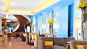A modern lobby with a curved staircase, comfortable seating, and decorative lamps. - The Westin Michigan Avenue Chicago (Chicago)