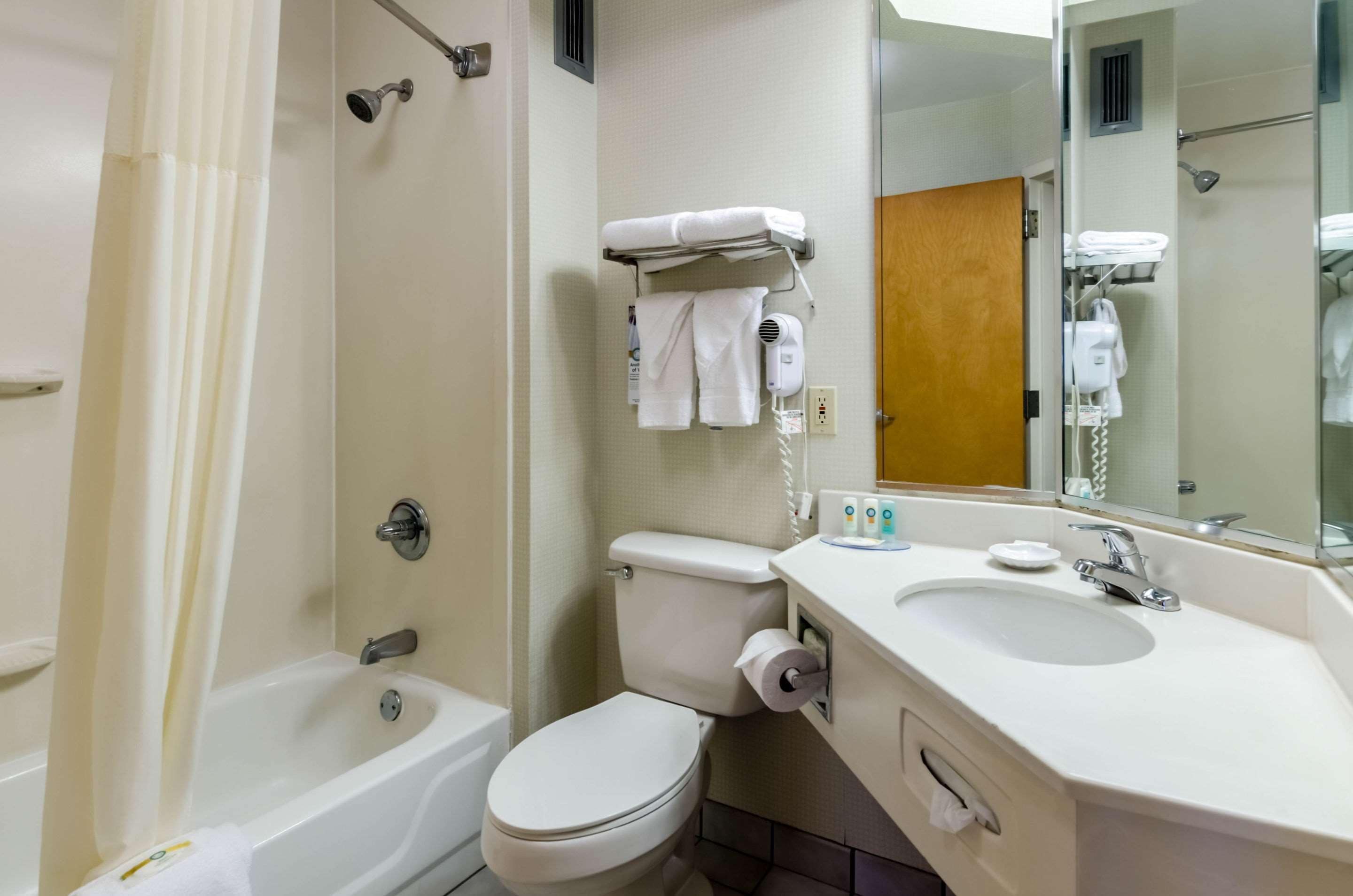 A bathroom with a bathtub, toilet, and sink.