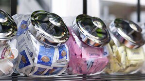 A shelf with various packaged food items, including coffee creamer and other dairy products. - Days Inn by Wyndham Oglesby/ Starved Rock (Oglesby)