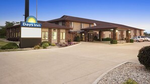 A Days Inn hotel with a brick facade, a large sign, and a parking area. - Days Inn by Wyndham Oglesby/ Starved Rock (Oglesby)