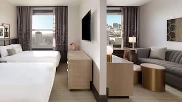 Una habitación de hotel moderna con una cama grande, un sofá, un escritorio con lámpara y un televisor.