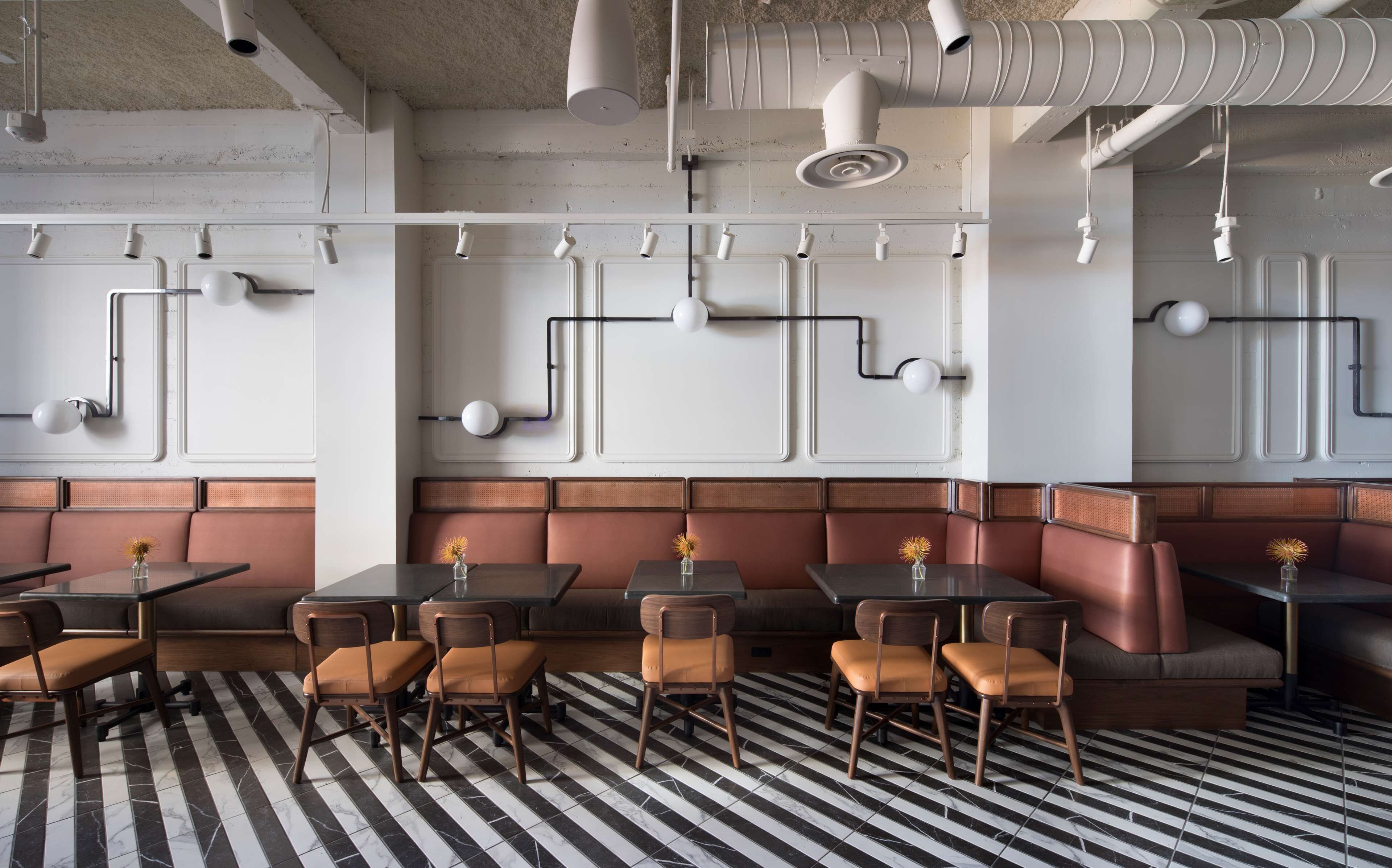 A restaurant interior with booth seating, tables, and chairs.