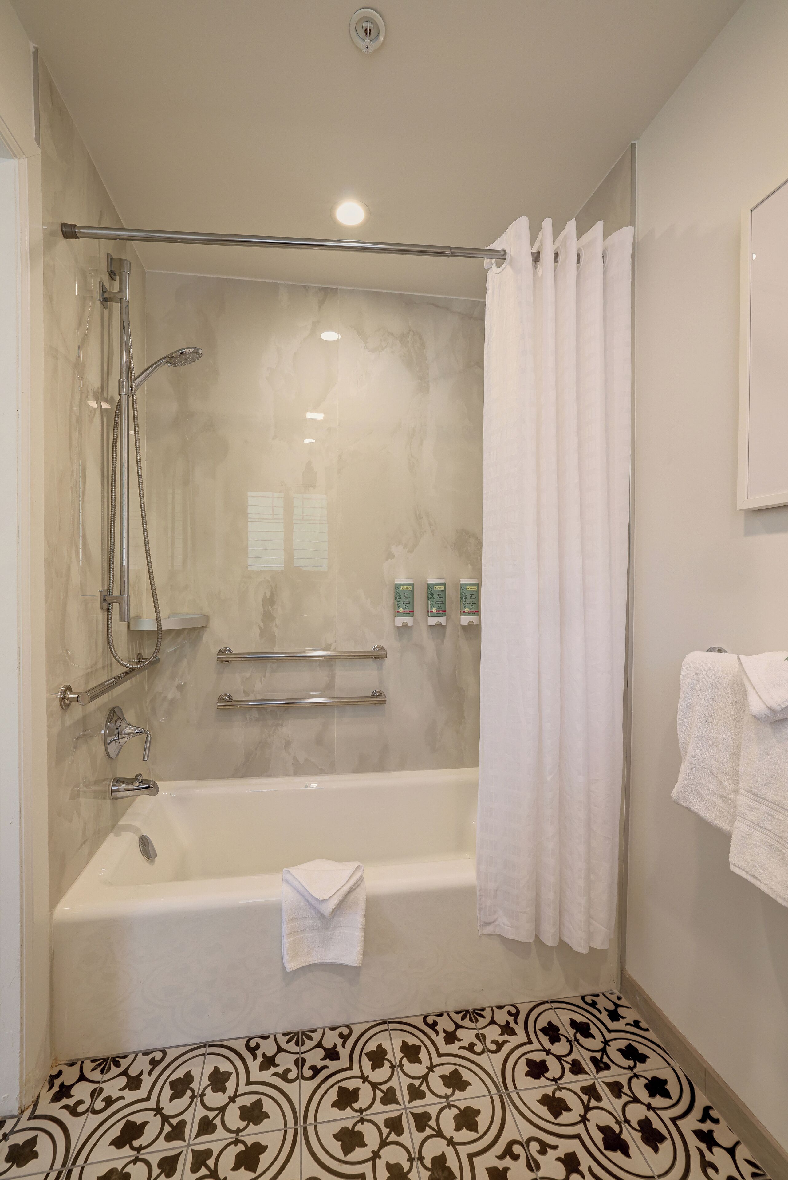 A modern bathroom with a walk-in shower, a bathtub, and a toilet.