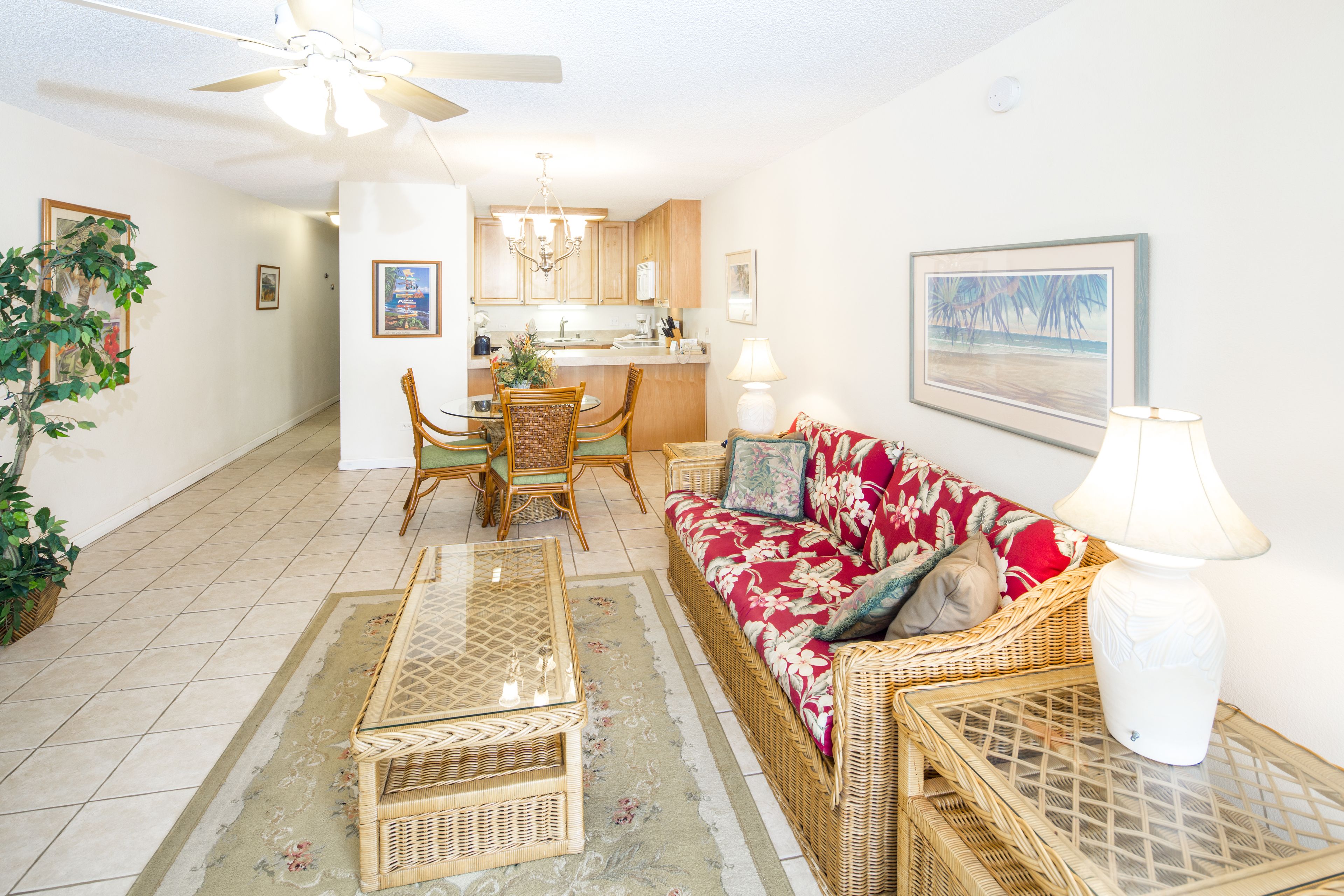 A living room with a sofa, chairs, a coffee table, and a dining table.