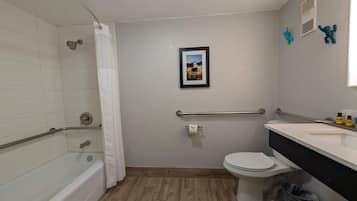 A bathroom with a bathtub, toilet, and shower.