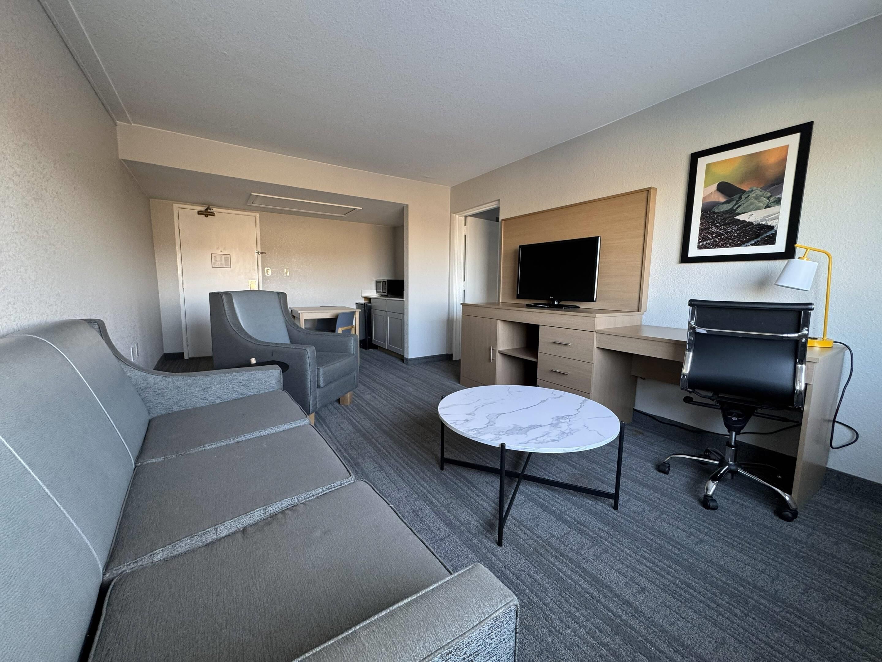 Desk, laptop workspace, iron/ironing board, bed sheets