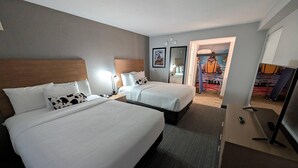 A hotel room with two beds, a desk, a TV, and a view of the hallway. - Comfort Inn & Suites Denver West - Golden (Golden)