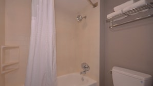 A bathroom with a bathtub, toilet, and towel rack. - Holiday Inn Express Fayetteville- Univ of AR Area by IHG (Fayetteville)