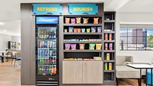 A vending machine labeled 'REFRESH' and 'NOURISH' with snacks and drinks. - Clarion Pointe Athens I-65 (Athens)
