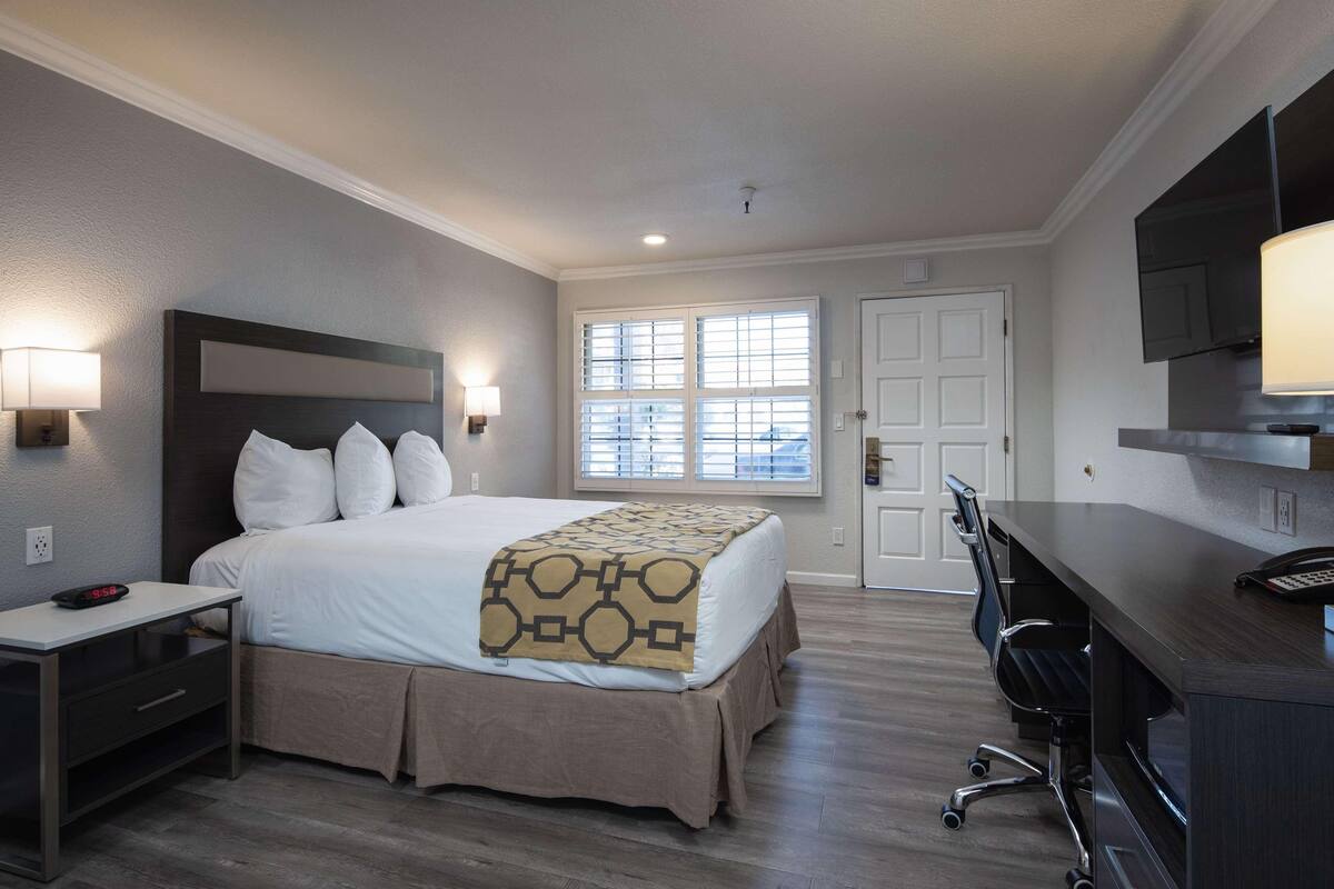 Premium bedding, desk, laptop workspace, iron/ironing board