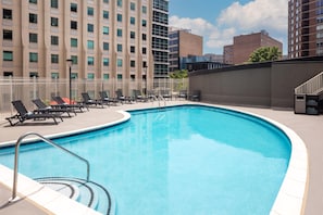 A swimming pool with lounge chairs and a white fence. - Doubletree by Hilton Washington DC Silver Spring (Silver Spring)