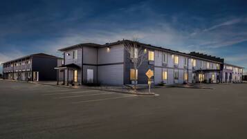 A multi-story hotel with a parking lot and a 'No Through Traffic' sign.
