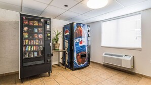 A vending machine area with a Pepsi dispenser and a push vending machine with various snacks. - Motel 6 Elk Grove Village, IL (Elk Grove Village)