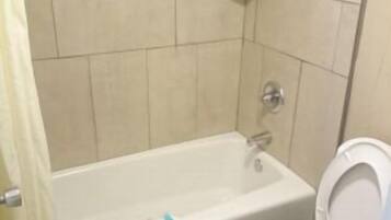Room, 1 King Bed, Non Smoking | Bathroom | Shower, free toiletries, hair dryer, towels