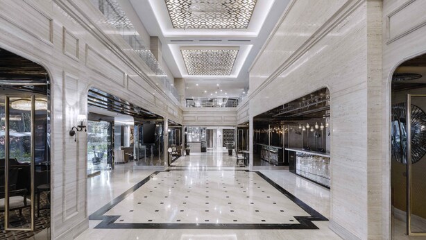 A spacious, well-lit hotel lobby with a polished marble floor, high ceilings with intricate ceiling designs, and modern furnishings. - Melia Kuala Lumpur (Kuala Lumpur)