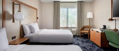 Premium bedding, desk, laptop workspace, blackout drapes