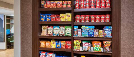 A snack shelf stocked with various brands of chips and snacks.