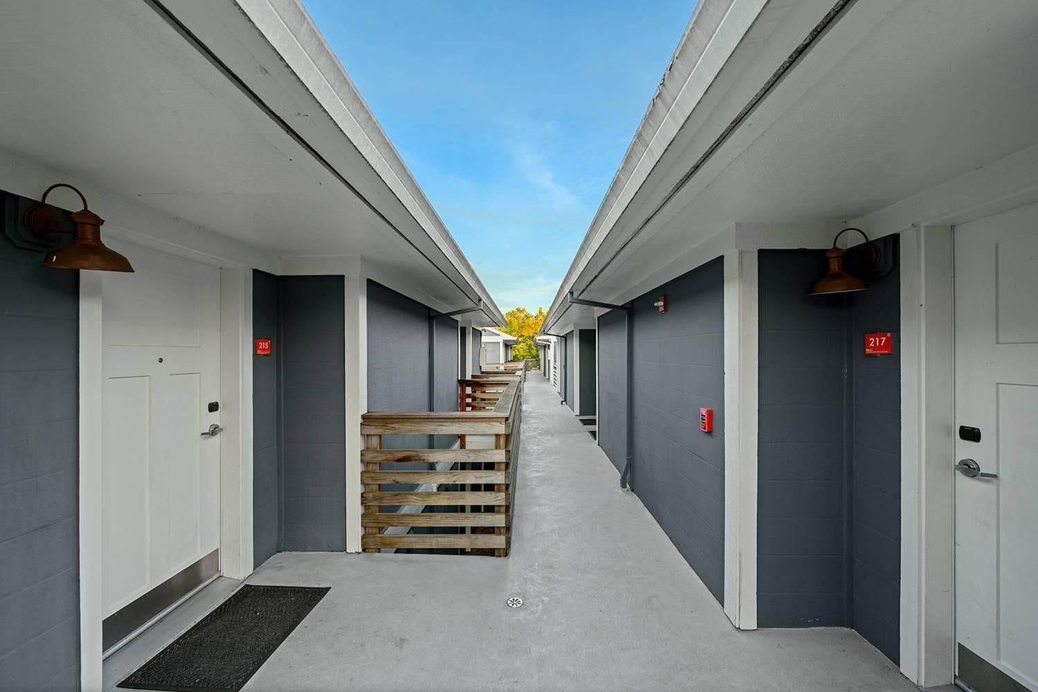 A corridor with multiple doors, each marked with a number.