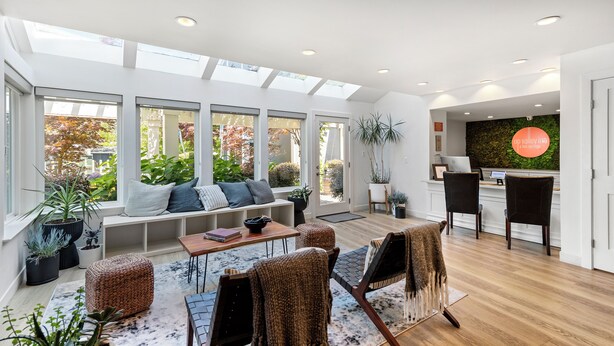 A bright, open-plan living area with a large window, a seating area, and a kitchen counter. - UpValley Inn & Hot Springs Napa Valley, an Ascend Collection Hotel (Calistoga)