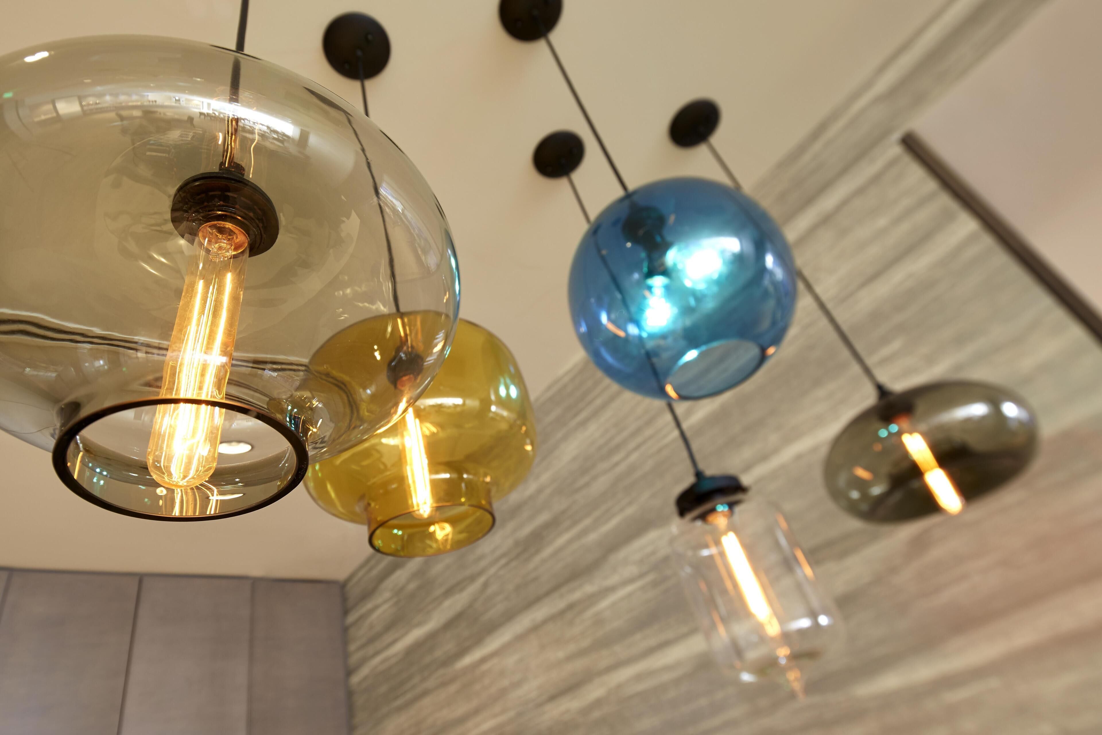 A ceiling with spherical glass fixtures and exposed bulbs.