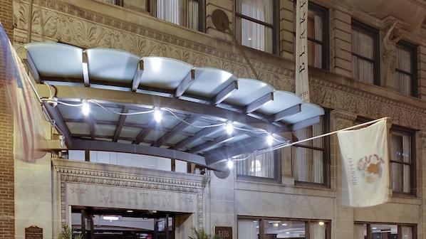 Experience the classic charm of this hotel's elegant entrance, featuring a beautifully adorned marquee and welcoming string lights.
