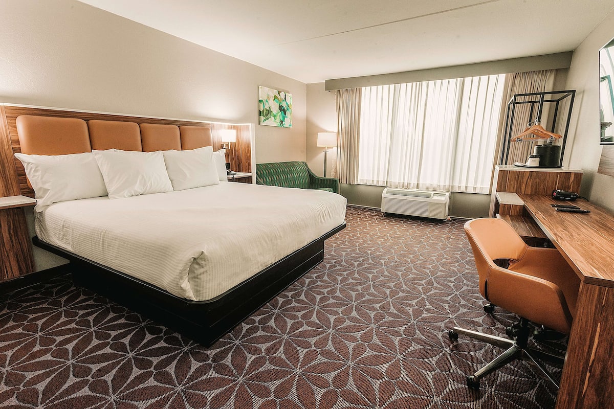 Premium bedding, desk, laptop workspace, blackout drapes